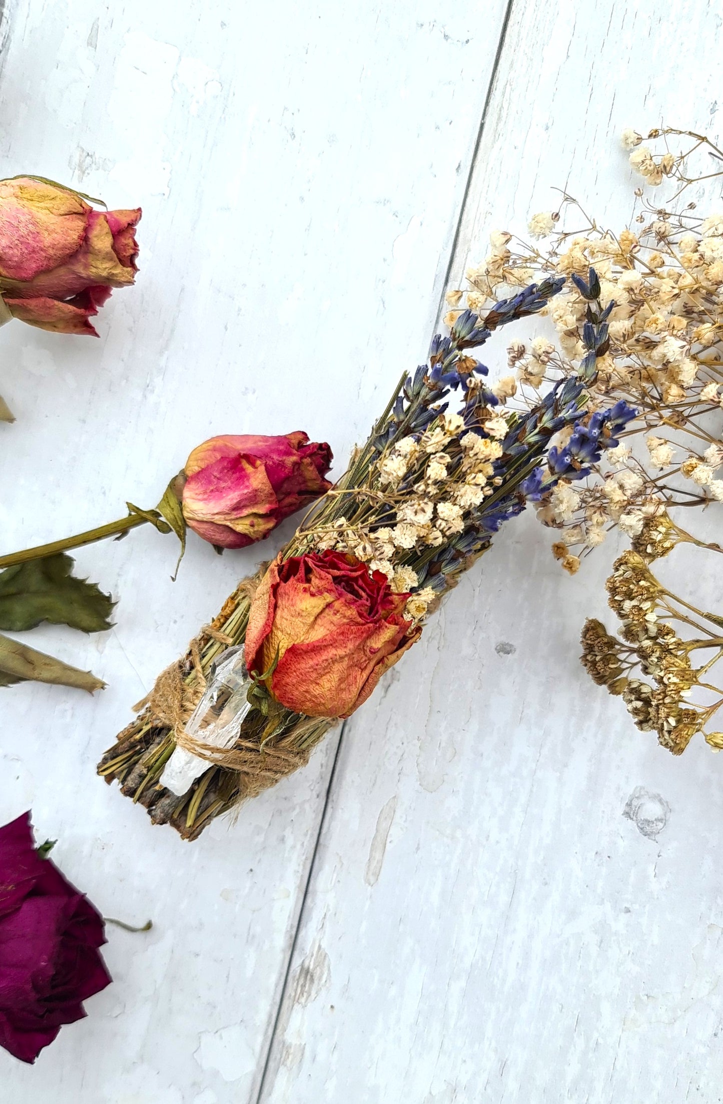 Pine smudge sticks decorated with flowers and quartz