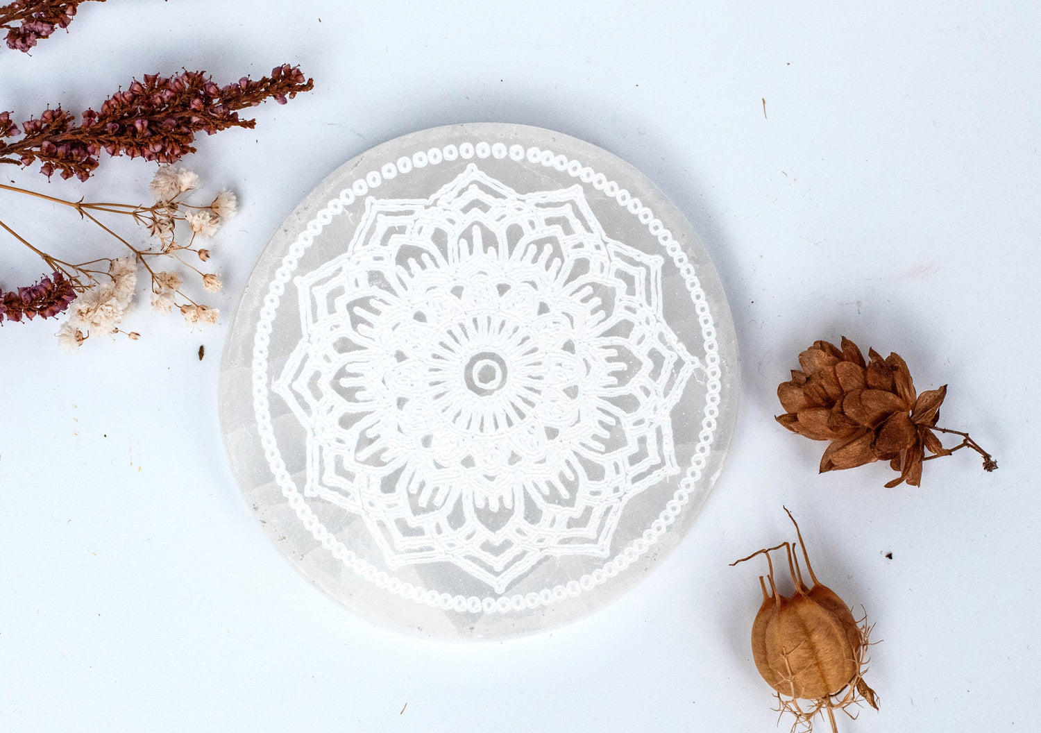 Selenite Plate carved with mandala symbols for harmony.