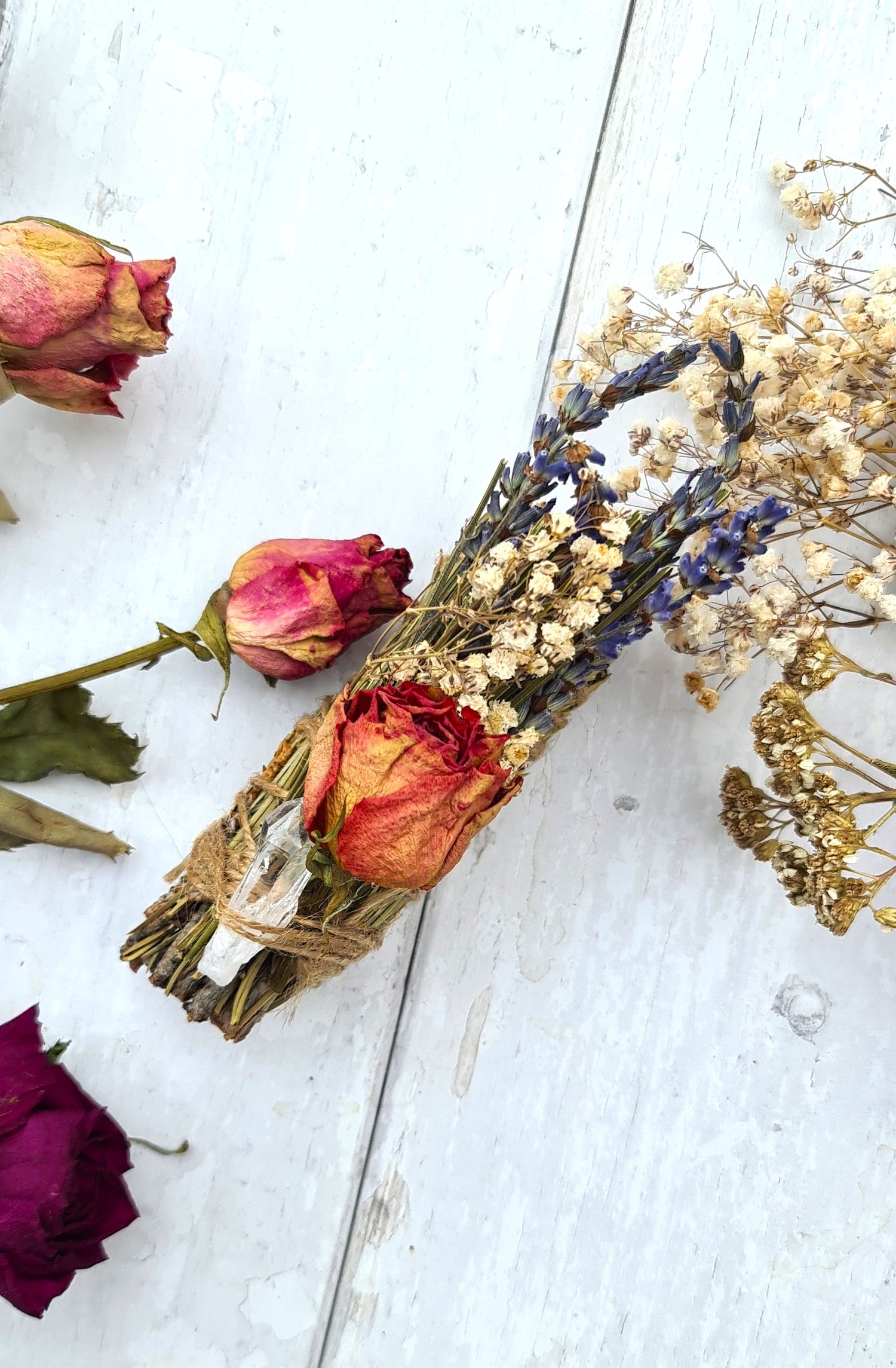 Pine smudge sticks decorated with flowers and quartz
