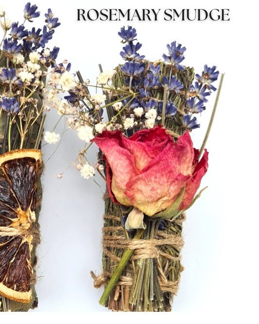 Rosemary smudge with dried flowers and a rose on a white background