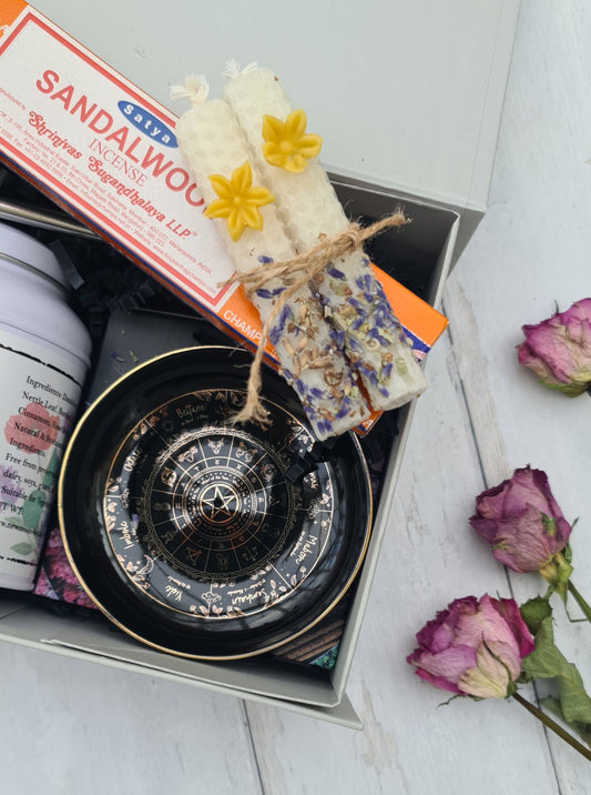 Sandalwood incense stick with decorative packaging and flowers on a white surface